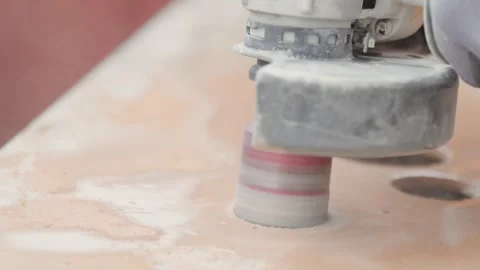 Close up of a power tool cutting holes in a ceramic tile. Circular cutter. Stock Footage 344059223