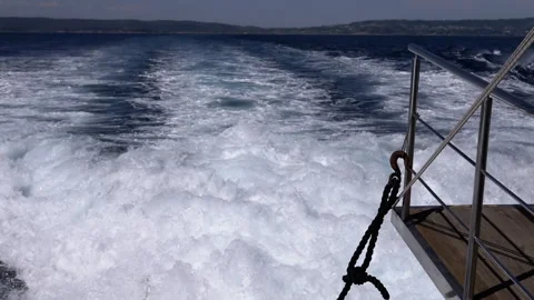 Close-up, powerful clear turquoise foaming waves, video of a boats wake on open Stock Footage 312522038