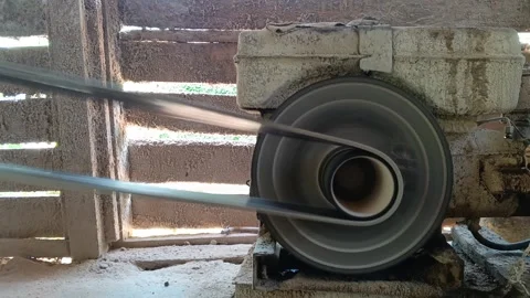 Close-up of a powerful diesel engine flywheel and belt rotating rapidly Stock Footage 318601472