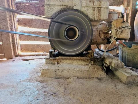 Close-up of a powerful diesel engine flywheel and belt rotating rapidly. Stock Photos