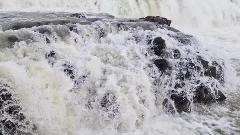 Close up of the powerful Gullfoss waterfall cascading over dark basalt rocks in Stock Footage 346326177