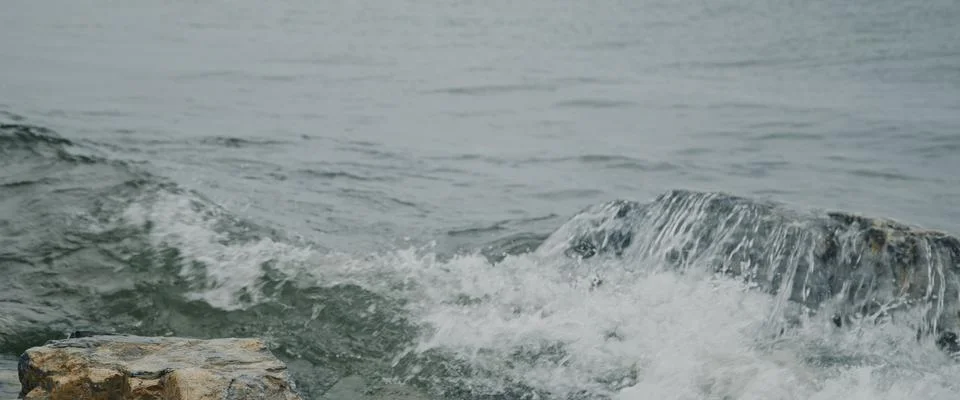 Close-up of powerful ocean waves dramatic near rocky shore on Nordic coast Stock Photos