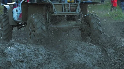 Close-up of a powerful off-road vehicle driving at high speed through deep mud Stock Footage 344876664