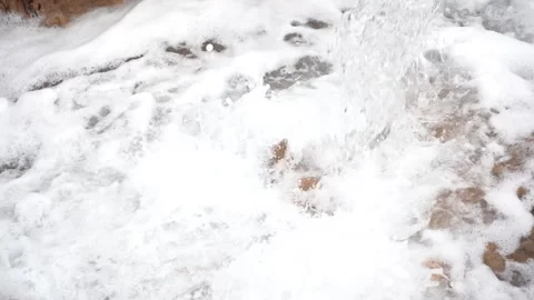 Close-Up of Powerful Water Stream Splashing into Foamy Muddy Pool Vídeos de archivo 334181437