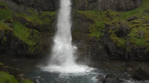Close up of powerful waterfall cascading over mossy rocks in Iceland 4K footage Stock Footage 339909803