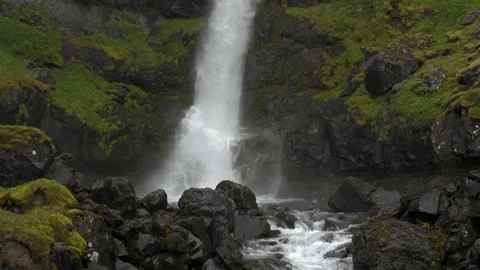 Close up of powerful waterfall cascading over mossy rocks in Iceland 4K footage Stock Footage 339910017