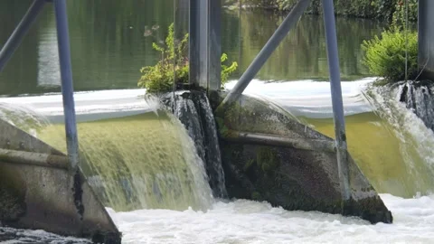 Close up of a powerful waterfall over the gates of a weir Stock Footage 317580249