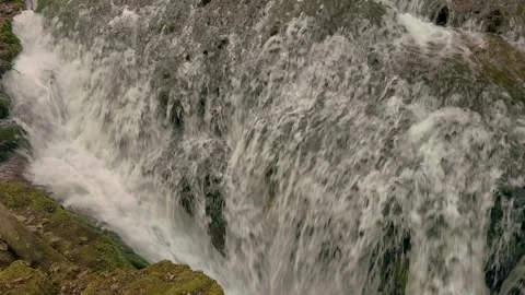 Close-Up of Powerful Waterfall Over Mossy Rocks 1 Stock Footage 314223740