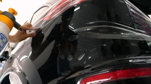 Close up to PPF installation process on a front (rear) headlight and bamper. Foto stock