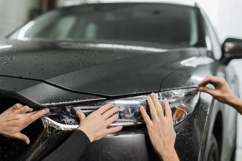 Close up to PPF installation process on a front headlight . 写真素材