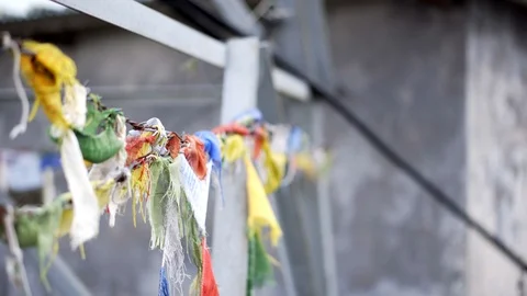 Close up of prayer flags on barbed wire in Nepal with shallow depth of field Stock Footage 91171564