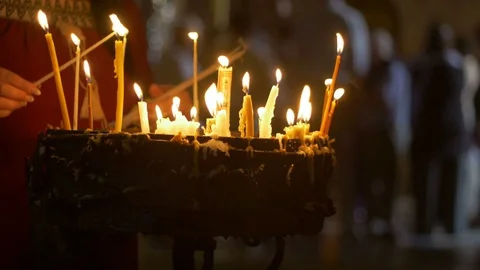 Close up of prayers hands lighting candles in the Holy Sepulchre Church in 스톡 동영상 70730729