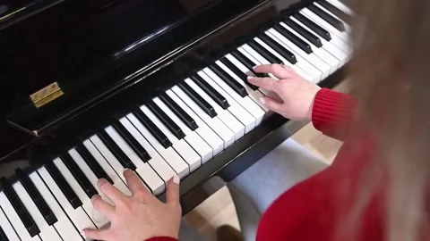 Close-up of precise finger technique on piano keys, showcasing mastery of Stock Footage 305652306