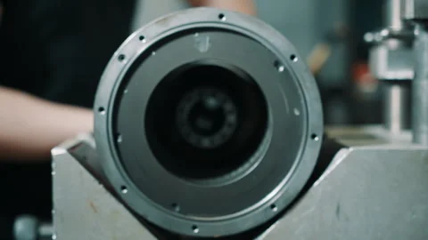 Close-up of a precision circular metal assembly as a perforated rotor is aligned Video stock 335860509