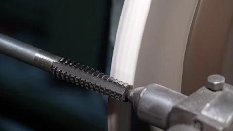 Close up of precision metal threading process on industrial grinding machine in  Stock-Footage 345265089