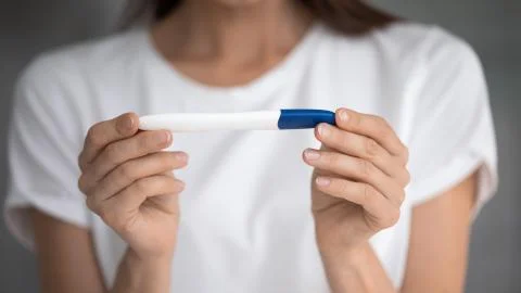 Close up pregnancy test in female hands of future mother. Stock Photos