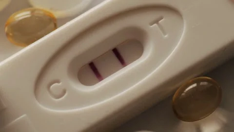 Close-up of pregnancy test kit showing double lines Positive pregnancy test Stock Footage 265933820