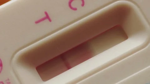 Close-up of pregnancy test kit showing double lines Positive pregnancy test Stock Footage 265933954