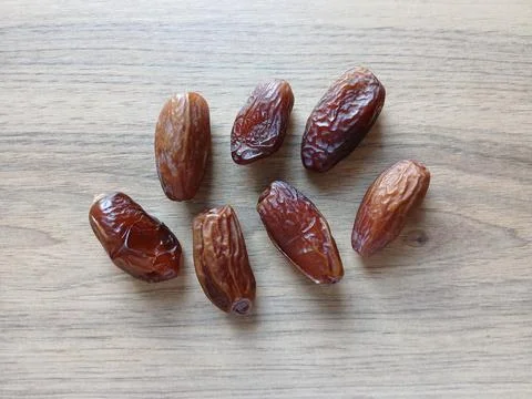 Close up of premium organic dried dates on a luxurious wooden table Stock Photos