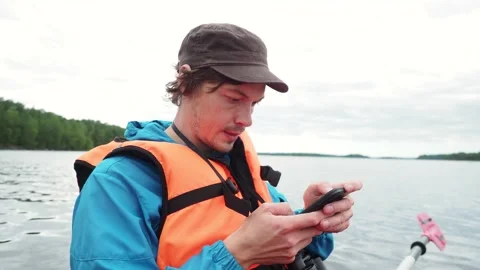 Close up. Preoccupied man checks location on smartphone online map sitting in Stock Footage 152250412
