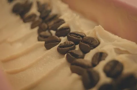 A close-up of the prepared base of handmade soap with coffee beans in silicone Foto stock