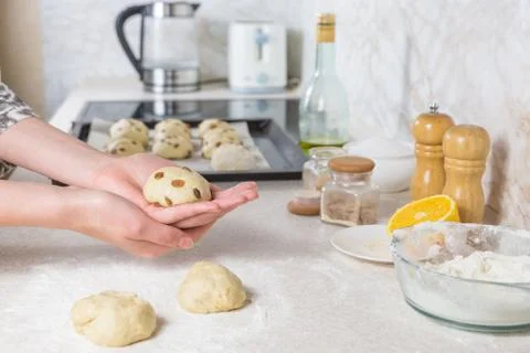 Close-up of preparing and forming easter cross buns with raisins out of dough Stock Photos