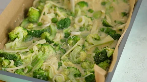 Close-up. Preparing broccoli and cheese frittata in a baking dish. Italian Stock Footage 146921477