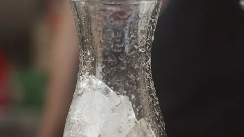 Close-up of preparing cool summer drink with ice poured blue curacao syrup Stock Footage 123824537