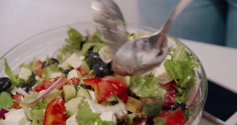 Close-up of preparing manually mixes greek vegetable salad. Vegetarian cuisine Stock Footage 132285183