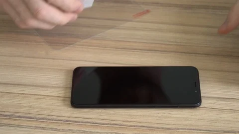 Close-up. Preparing the screen for a new mobile phone. Cleaning with a damp Stock Footage 86821313