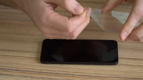 Close-up. Preparing the screen for a new mobile phone. Cleaning with a damp Stock Footage 86842572