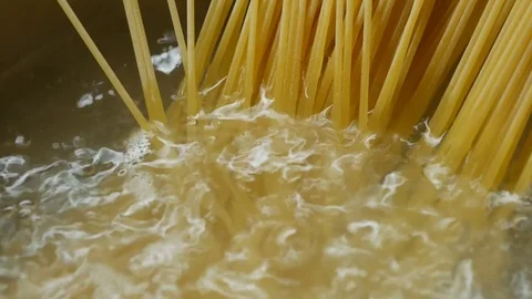 Close-up of preparing spaghetti in boiling water Stock Footage 82316345