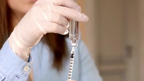 Close up preparing a vaccination to be injected a doctor puts a needle on a Stock-Footage 336587056