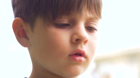 Close up of a preschool aged boy thinking and concentrating while learning Stock Footage 80012647