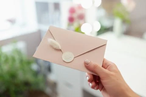 Close up on present envelope in hand of a cosmetologist beautician Stock Photos