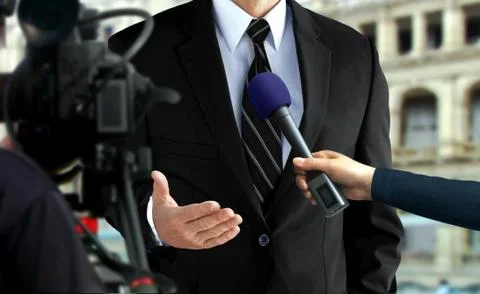 Close-up press interview with a man in black suit Stock Photos