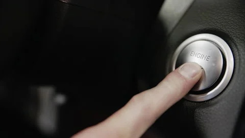 Close-up of pressing the engine start and stop button on a modern keyless Stock Footage 135180837