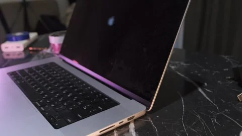 Close-up of pressing the laptop power button to start the device, showing Stock Footage 333649452