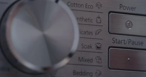 Close Up of Pressing Start Pause button on washing machine Stock Footage 172384935