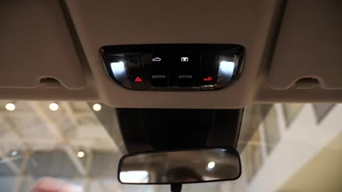 Close-up of pressing the sunroof control button in the ceiling of the car Stock Footage 270157385