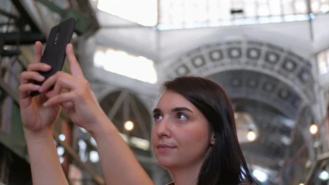 Close up of a pretty brunette taking selfies in a food market Stock-Footage 122640989