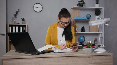 Close up of pretty concentrated industrious young businesswoman in eyeglasses Stock Footage 124702852
