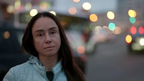 Close-up of a pretty female face looking into the camera outdoors. An adult lady Stock-Footage 166807426