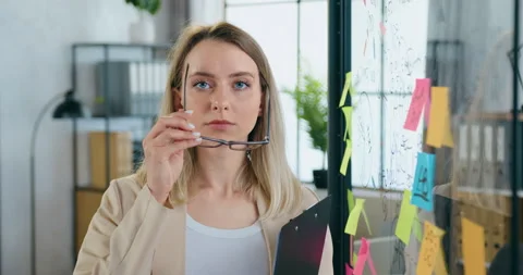 Close up of pretty serious experienced 30-aged blond woman which looking into Stock Footage 158004775