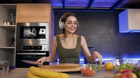 Close up of pretty smiling happy young woman which eating apple while listening Stock Footage 127289255