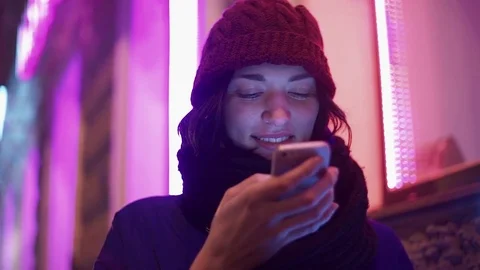 Close up of pretty young woman using app on smart phone at night in city. Stock Footage 83072730