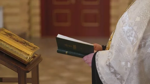 Close-up of the priest's hands with the Bible. The Holy Father reads a prayer Stock Footage 169165591