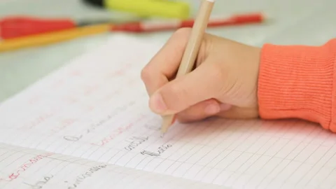 Close up of primary school kid hand while doing homework,education lifestyle Stock Footage 157113231