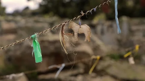 Close-up: primitive decorations on the rope - ribbons, a horse. Stock Footage 162750794