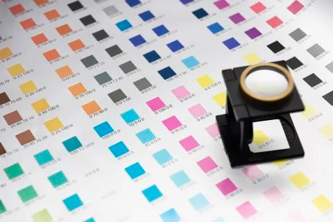 Close up of print color checking process with magnifying glass Foto stock